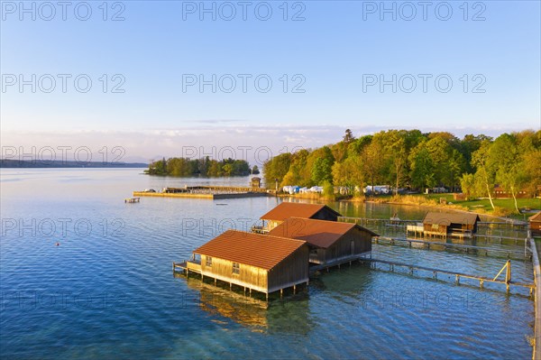 Boathouses and Rose Island in Lake Starnberg near Feldafing in the morning light