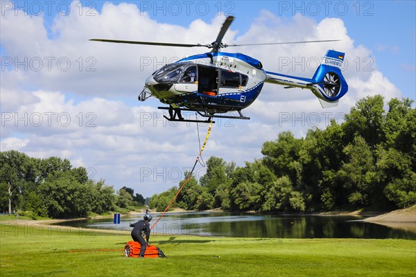 Police helicopter Airbus H 145 during exercise with fire water tank BAMBI BUCKET