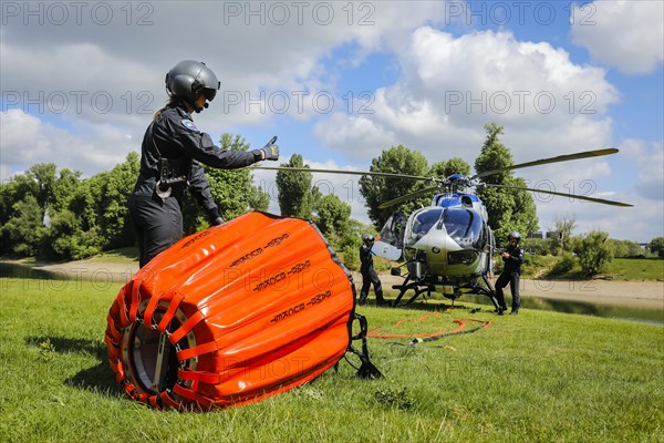 Police helicopter Airbus H 145 during exercise with fire water tank BAMBI BUCKET