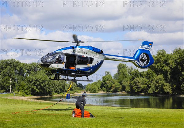 Police helicopter Airbus H 145 during exercise with fire water tank BAMBI BUCKET