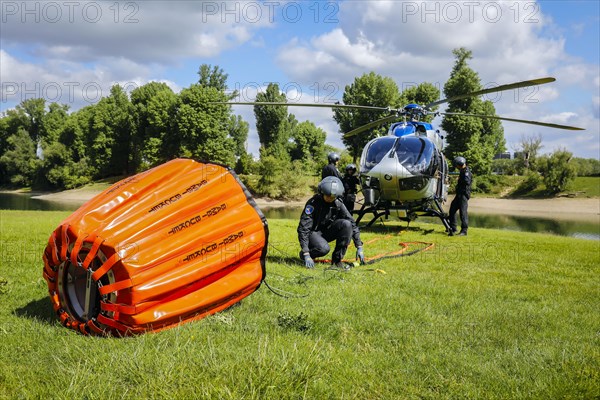 Police helicopter Airbus H 145 during exercise with fire water tank BAMBI BUCKET