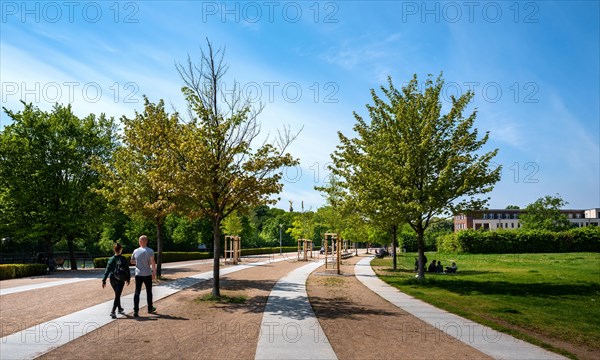 Walkers on the Spree river bank promenade near Bellevue Palace