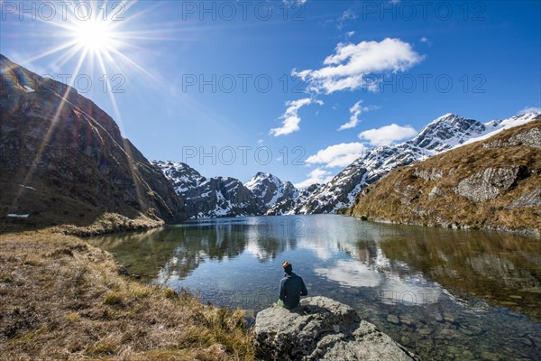 Young man sitting on a rock