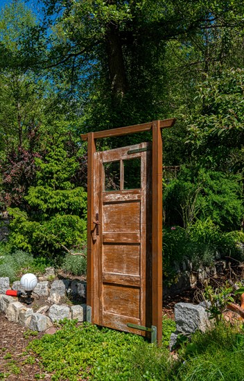 Old brown wooden door as garden decoration