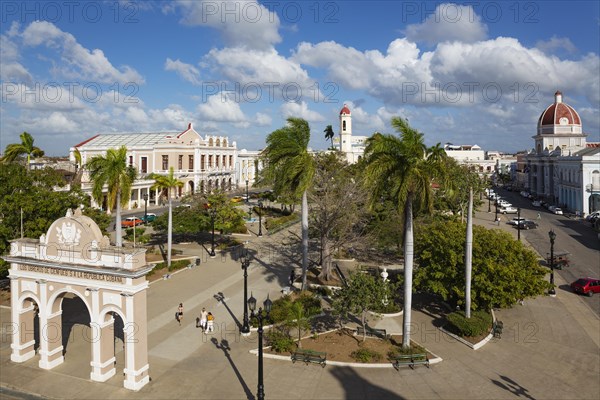 Porticoed Neoclassical buildings frame the Parque Jose Marti