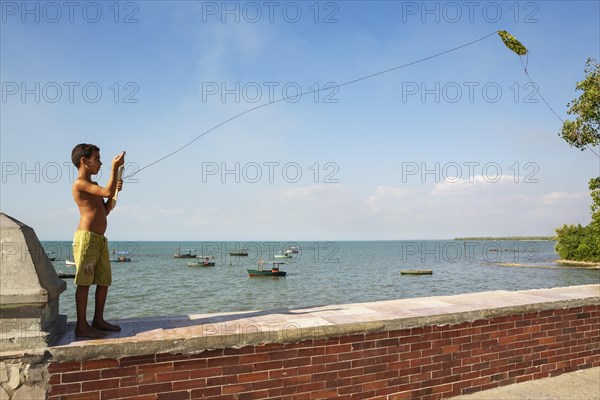 Boy playing with a kite at the Malecon of Manzanillo