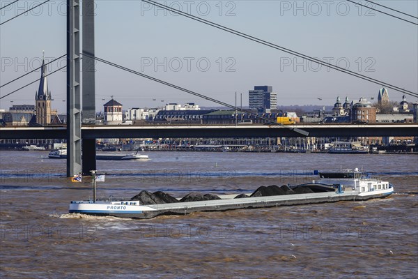 Freighters navigating at high water on the Rhine under the Rheinkniebruecke