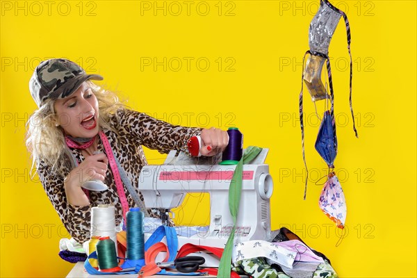 Young woman with sewing machine