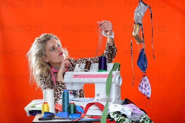 Young woman with sewing machine