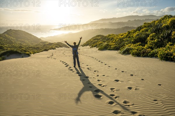 Young man stretching his arms in the air