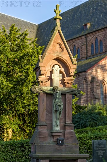 Crucifix in front of the neo-gothic collegiate church of St. John the Baptist