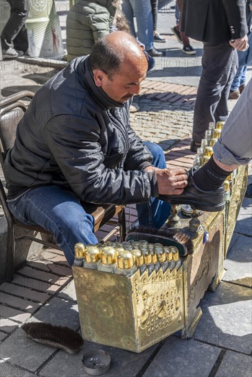 Shoeshine boy cleaning shoes