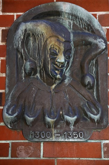 Metal sign by Till Eulenspiegel on a house in the old town of Moelln