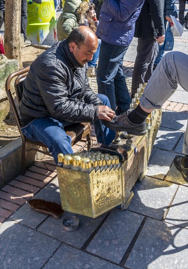 Shoeshine boy cleaning shoes