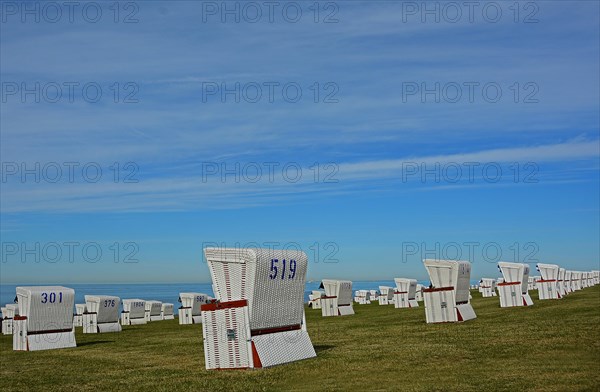White beach chairs at the dike