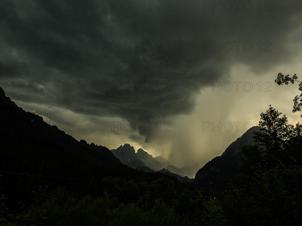 Thunderstorms and rain clouds over mountain peaks