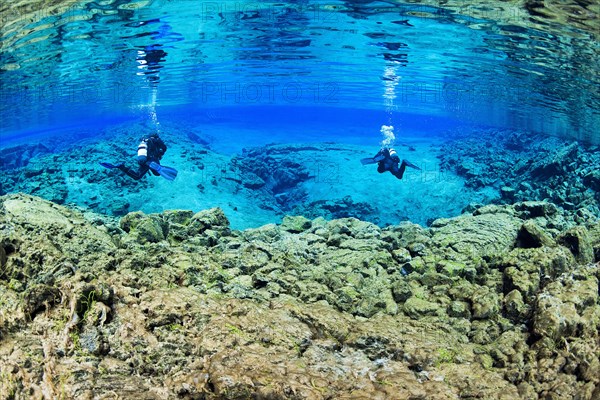 Two divers in the Silfra Lagoon