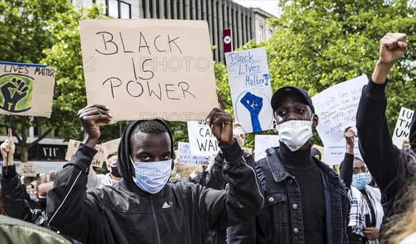 Dark-skinned demonstrators with poster with the inscription Black is Power