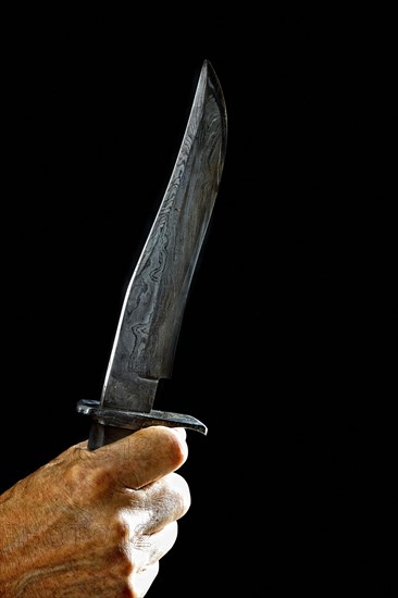 Hand with Damascus knife