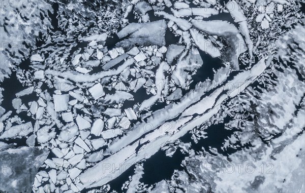 Partly frozen lake with ice floes