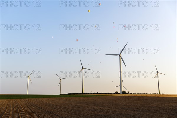 Wind turbines between fields