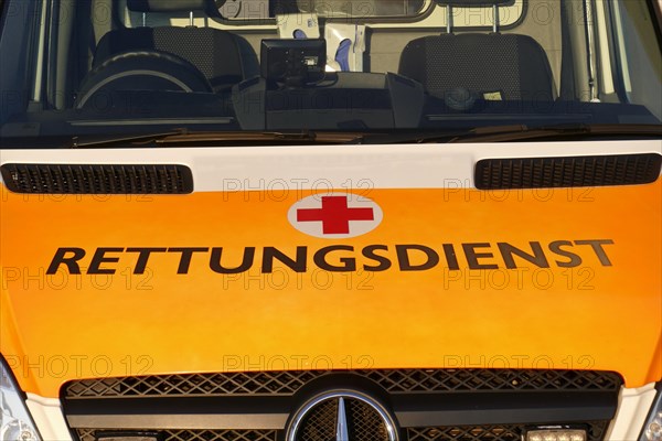 Lettering rescue service and Red Cross logo on an ambulance