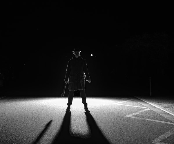 Woman with big knife in backlight with black shadow