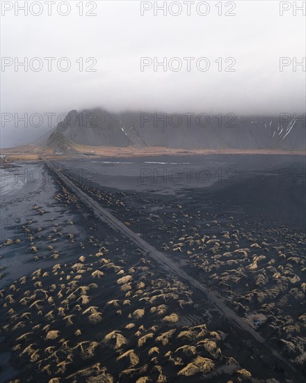 Street at Stokksnes Beach from the air with clouds