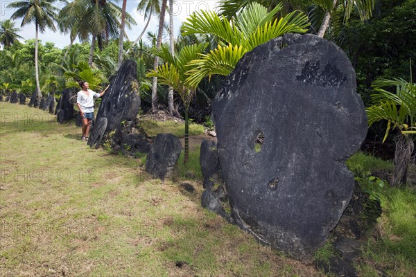 Tourist in front of stone money