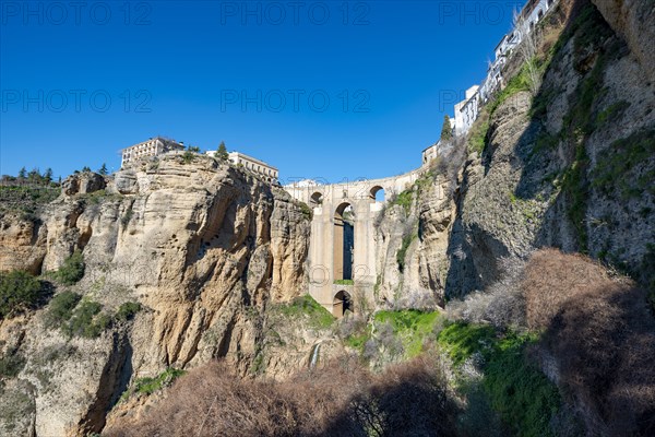 Bridge Puente Nuevo with waterfall at steep cliffs