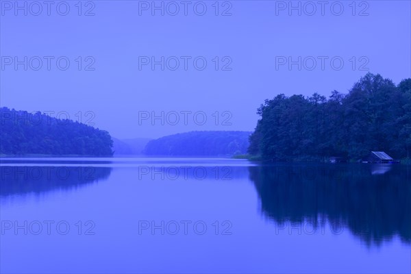 Blue hour at the lake Schmaler Luzin with boathouse