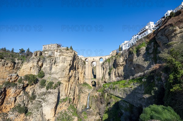 Bridge Puente Nuevo with waterfall at steep cliffs