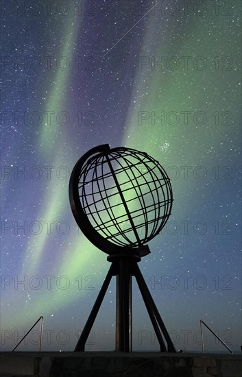 Steel globe at North Cape with northern lights