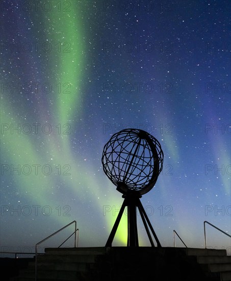 Steel globe at North Cape with northern lights