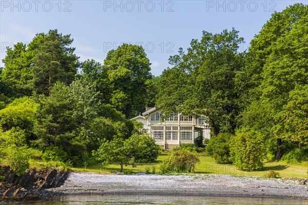 Old Norwegian wooden house on the beach of the Oslofjord in the district Bygdoy