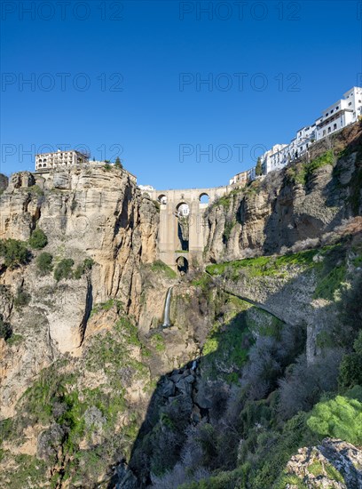 Bridge Puente Nuevo with waterfall at steep cliffs