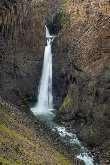 Waterfall Litlanesfoss between columnar basalt
