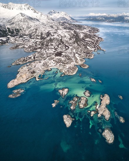 Aerial view of Senjehestneset bay with offshore archipelago islands and turquoise sea bed