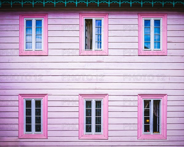 Pink wooden facade with windows