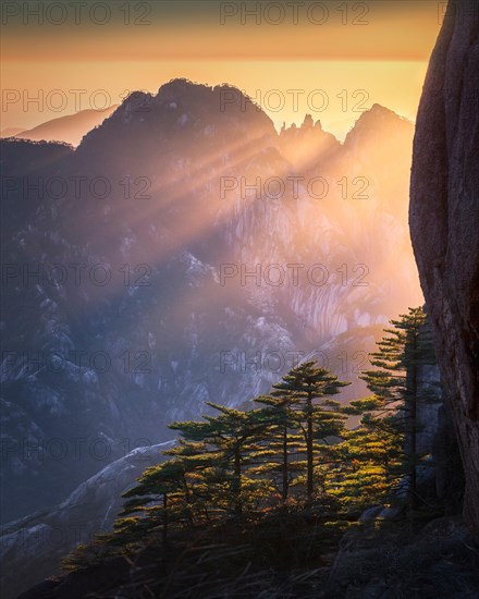 Beautiful sunset in Yellow mountains. Huagshan mountains is famous with rocky mountains and pine trees. Anhui province