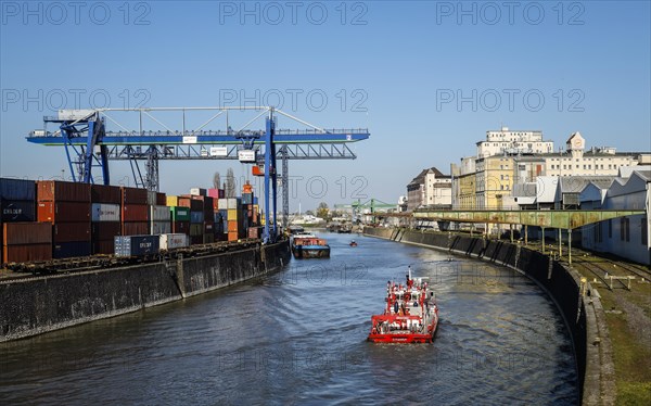 Harbour crane loads container ship with containers