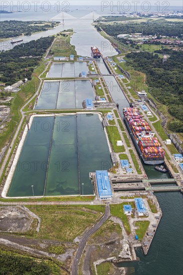 Aerial view of two Neo-Panamax container ships crossing the third set of locks at the pacific side