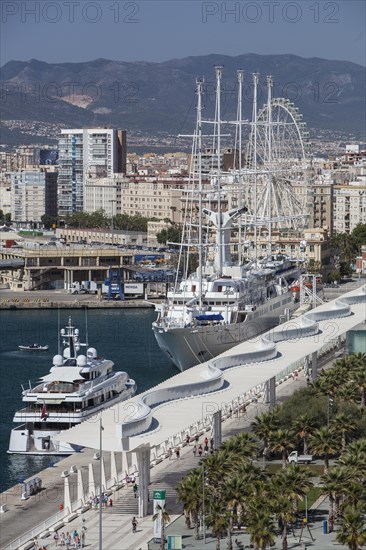 Luxury yachts and Palmeral De Las Sorpresas in the port of Malaga