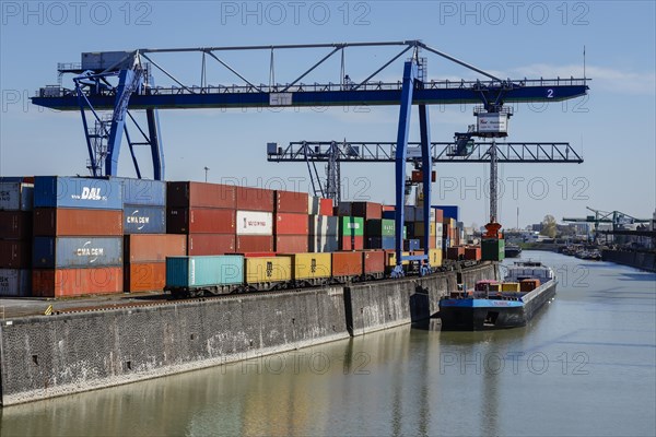 Harbour crane loads container ship with containers