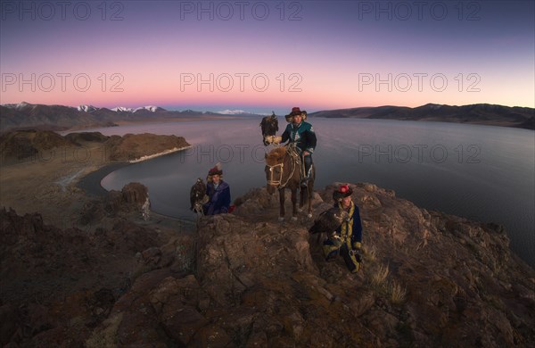 Eagle hunters with their trained eagles in Tolbo lake. Bayan-Ulgii province