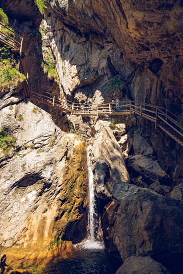 Hiking trail through gorge with waterfall