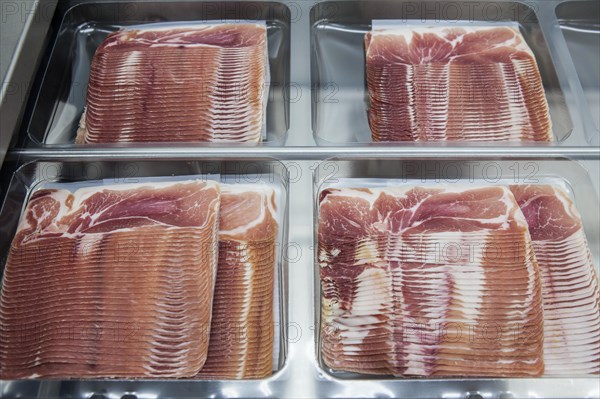 Cured ham being packaged