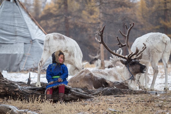 Reindeer herder girls with reindeer