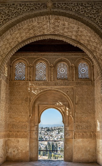 View of the Albayzin district through arched windows decorated with arabesques