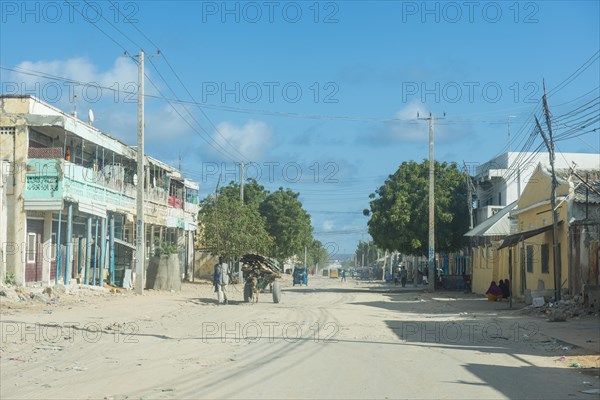 Somali woman before the destroyed houses of Mogadishu